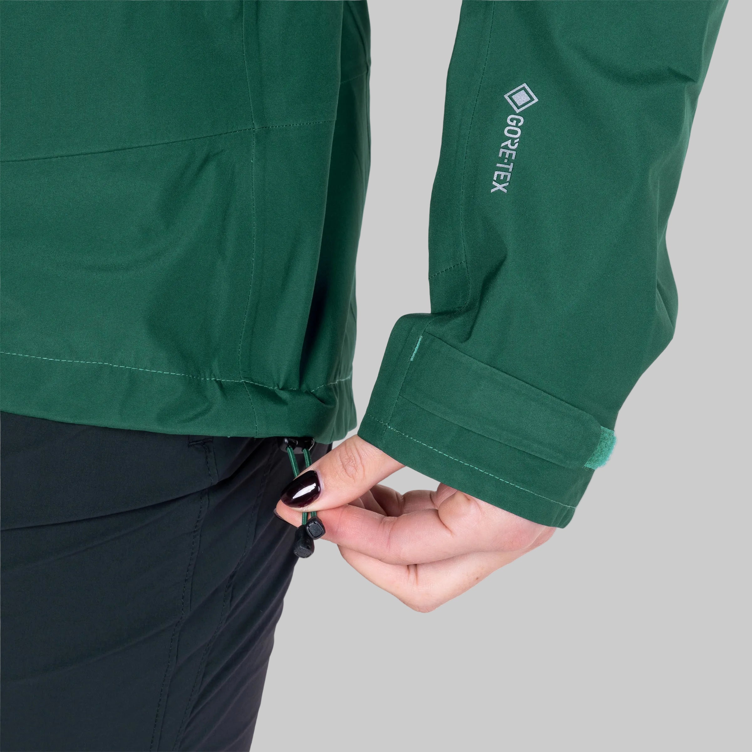 Green jacket with GORE-TEX logo on a white background